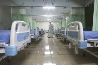 A medic inspects makeshift isolation rooms at Patriot Candrabhaga stadium amid the new coronavirus outbreak in Bekasi, on the outskirts of Jakarta.
