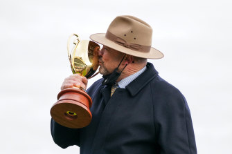 Trainer Peter Moody kisses the Caulfield Cup after Incentivise’s win.