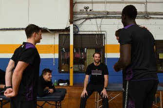 Chase Buford talks with Kings players before a training session.