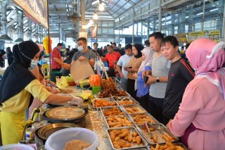 People shop at a local market in Bandar Seri Begawan, Brunei’s capital. Restrictions and protocols including mask wearing have now been re-imposed.