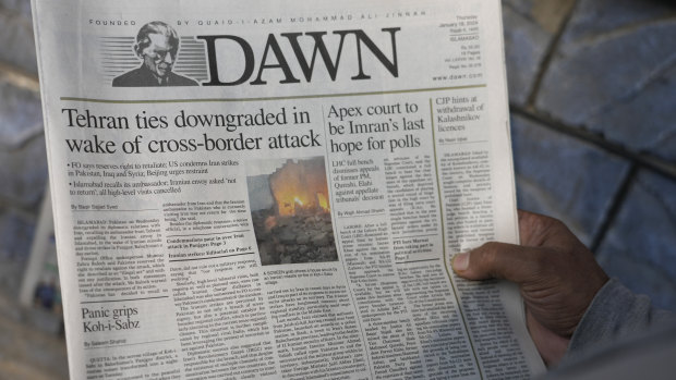 A Pakistani man reads the front page of a morning newspaper covering the Iranian strike at a kiosk in Islamabad, Pakistan, on Thursday.