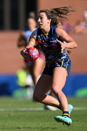 Adelaide’s Niamh Kelly navigates her way through traffic against brisbane.