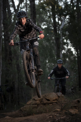 Silas Statheos and Noah Przydacz ride a downhill trail after a day of home learning in the lower Blue Mountains.