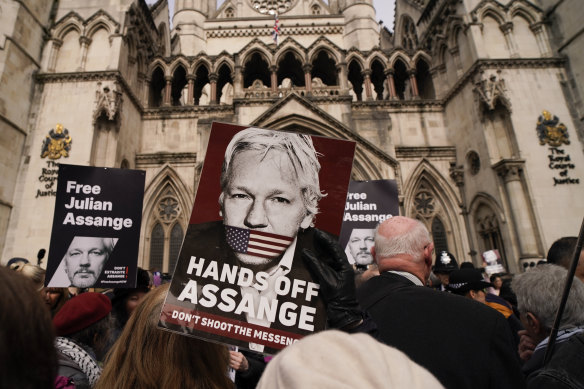 A demonstrator holds a placard calling for the release of Julian Assange outside the Royal Courts of Justice in London on Tuesday.