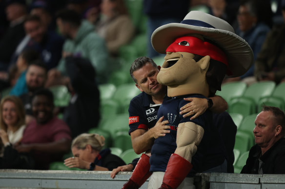 Game over  . . . a fan hugs the Melbourne Rebels mascot.