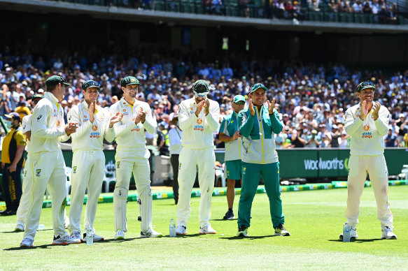 Justin Langer applauding with the Australia team as Scott Boland is awarded the Mullagh Medal.