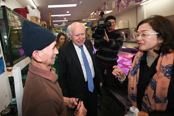 Glen Waverley fish shop owner Due Huu Vi (left) with former PM John Howard and Liberal MP Gladys Liu.