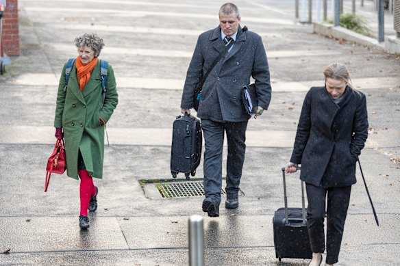 Prosecutors Nanette Rogers, SC (left), and Jane Warren (right) arrive at court on Tuesday with Detective Leading Senior Constable Stephen Eppingstall.