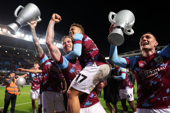 Burnley players celebrate winning the Championship title.