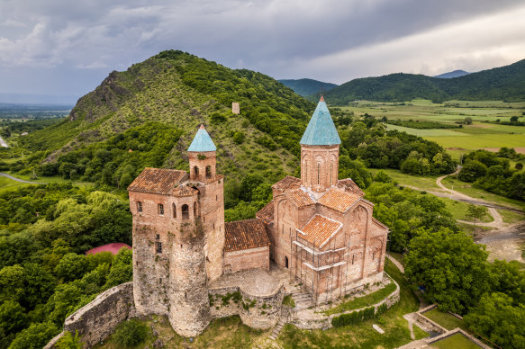 The imposing Gremi castle and church, surrounded by lush greenery.