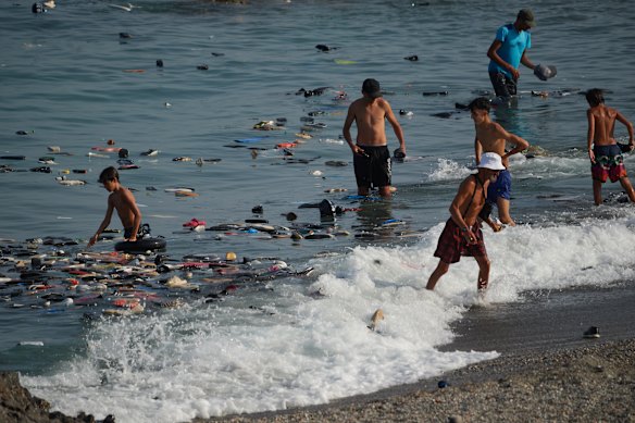 Belongings left behind by migrants float in the sea.