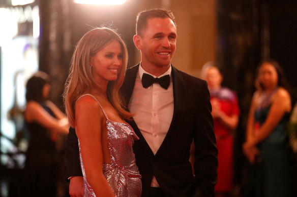 All smiles, no chat ... Brit and Joel Selwood.