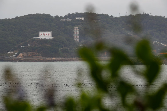 A billboard with a message reminding people to be ready to fight is seen on the Taiwanese island of Matsu that is close to Fujian, China.