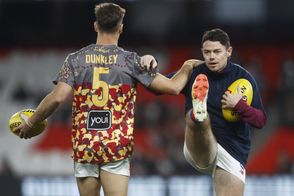 Lachie Neale (right) and Josh Dunkley loosen up.