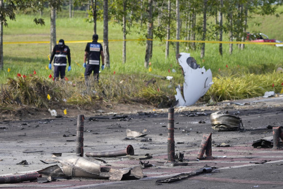 Members of the fire and rescue department inspect the crash site.