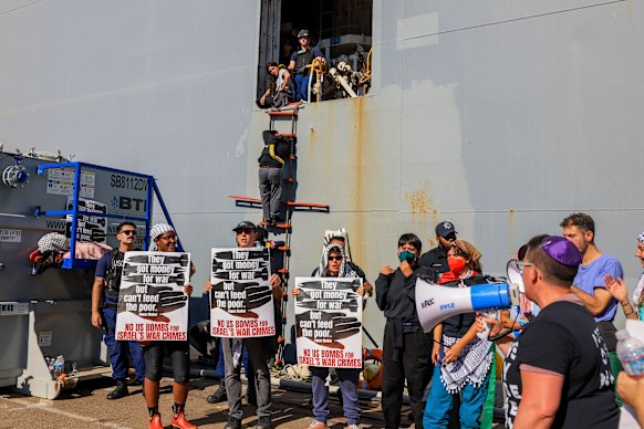 Anti-war protesters in Oakland lock themselves to a ladder of a ship they believe to be transporting military supplies to Israel.