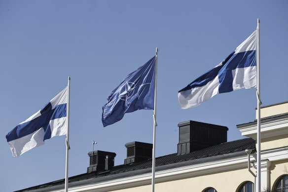 Finnish and NATO flags flutter at the courtyard of the Foreign Ministry in Helsinki, Finland.