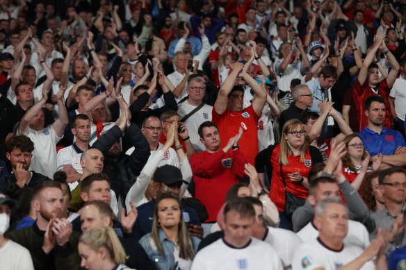So close: England fans applaud their team despite the defeat. 