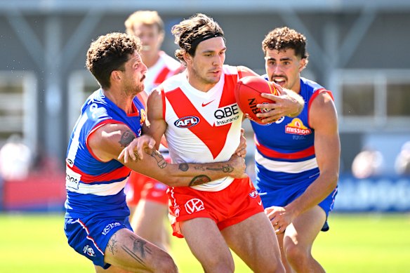 Tom Liberatore wraps Errol Gulden up in a tackle.