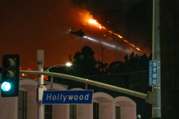 Helicopters are seen making water drops during the Sunset fire.