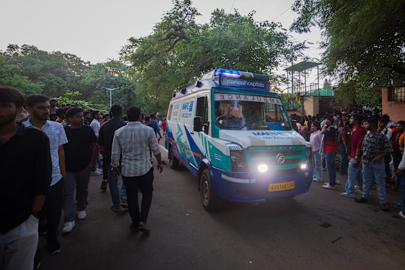 An ambulance makes its way past fans outside the M. Chinnaswamy Stadium on Thursday.