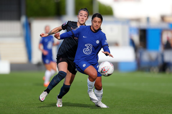 Chelsea's Sam Kerr holds off City's Lucy Bronze at Kingsmeadow on Sunday.