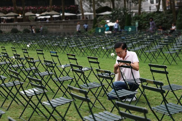 A mourner places a flower on one of 2753 empty chairs in New York’s Bryant Park, each signifying a life lost in the terrorist attacks on the World Trade Centre.