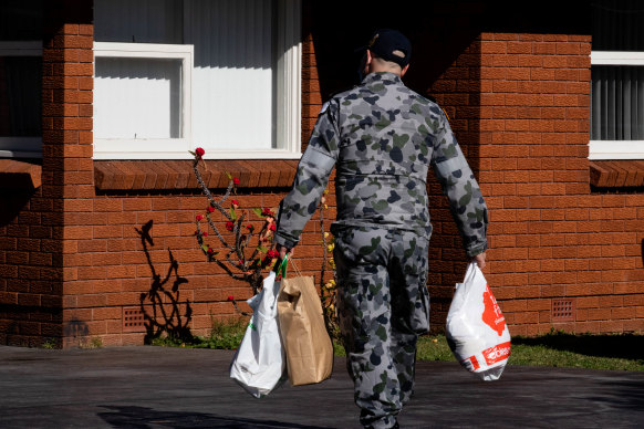 A Defence Force member delivers groceries to people in isolation during Sydney’s lockdown mid-2021.
