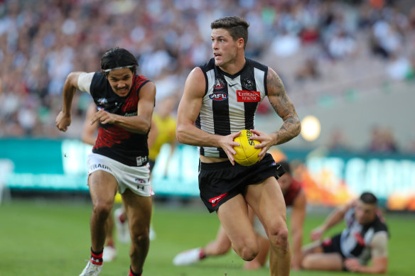 Collingwood midfielder Jack Crisp leaves Alwyn Davey jnr of Essendon.