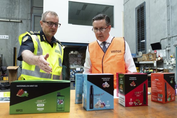 Australia’s Border Force Commissioner Michael Outram and Minister for Health and Aged Care Mark Butler inspect a consignment of seized vapes.