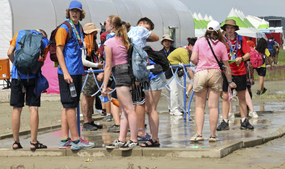 World Scout Jamboree attendees soak in water at a campsite in Buan, South Korea, on Friday.