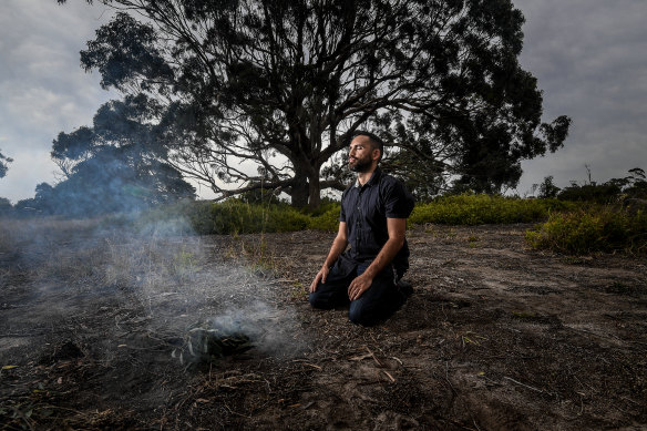 Gunnai man Stephen Thorpe burns leaves near the site of the Warrigal Creek massacre in South Gippsland.