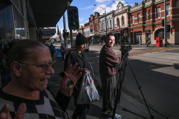 Walsh (right), the creator of Garden State Journal, filming on Sydney Road in Brunswick.