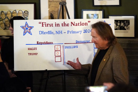 Town moderator Tom Tillotson stands at the tally board after voters cast their ballots at midnight in the presidential primary election in Dixville Notch.