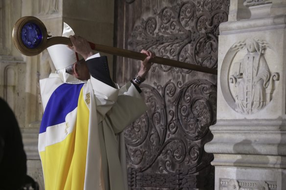 Archbishop of Paris Laurent Ulrich knocks on the doors of Notre-Dame Cathedral.