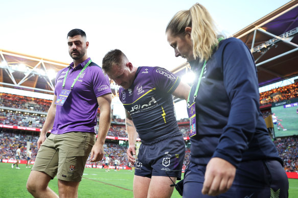 Cameron Munster limps from the Suncorp Stadium turf after suffering a groin injury.