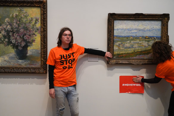Just Stop Oil climate activists glue themselves to a Van Gogh painting at the Courtauld Gallery in London in June. 