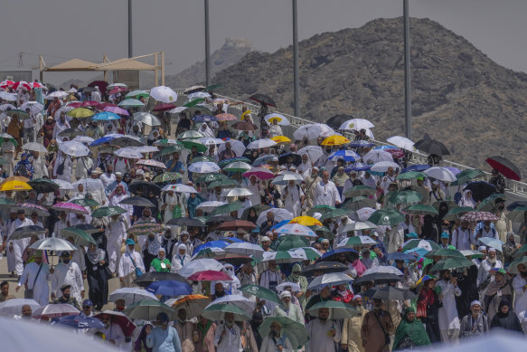 Muslim pilgrims use umbrellas to shield themselves from the sun.