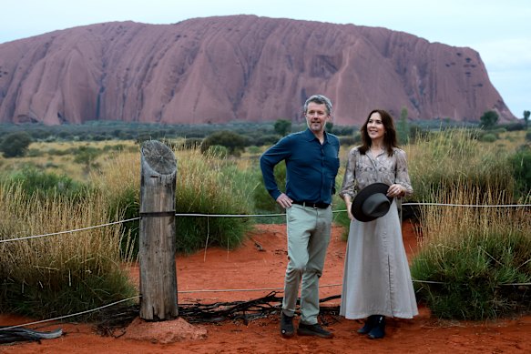 King Frederik X and Queen Mary pose for photos in front of  Uluru. 