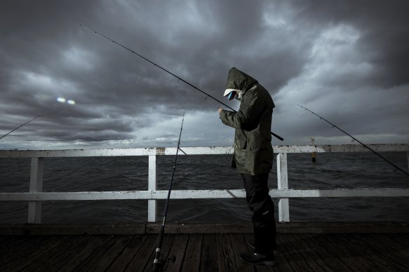 Carlie Hung fishing in Port Melbourne.