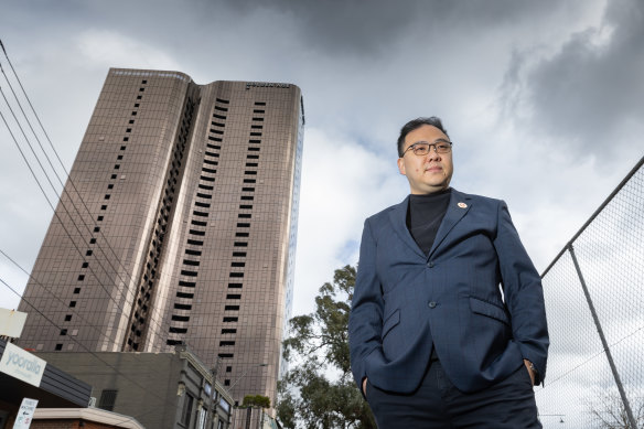 Richard Shi, standing in front of the 36-storey Sky one apartment tower, says Box Hill is comfortable and convenient for Chinese migrants. 