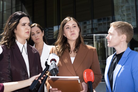 Brittany Higgins, centre, spoke outside the ACT Supreme Court after the first trial was aborted, with Heidi Yates standing on the right.