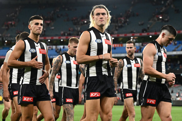 The Magpies looking dejected after losing their round one AFL match against the Sydney Swans at the MCG on Friday night.