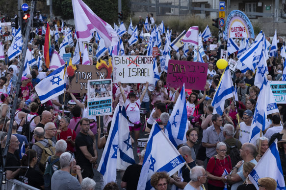 Protesters hold signs and flags during a demonstration calling for a hostages deal and against Israeli Prime Minister Benjamin Netanyahu and his government.