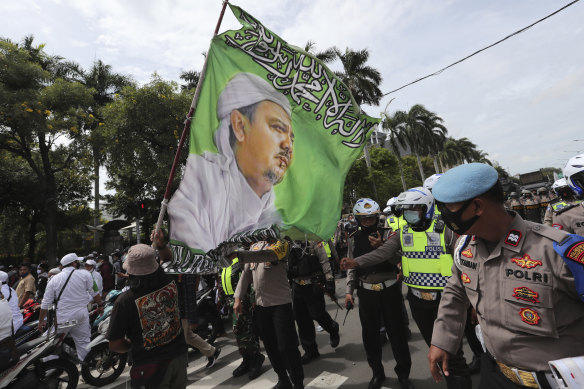 Hundreds of protesters marched in Jakarta on Friday December 18 to demand the release of the firebrand cleric who is in police custody on accusation of inciting people to breach pandemic restrictions.