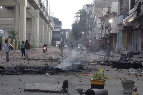 A vandalised street following violence between two groups of protesters in New Delhi, India.