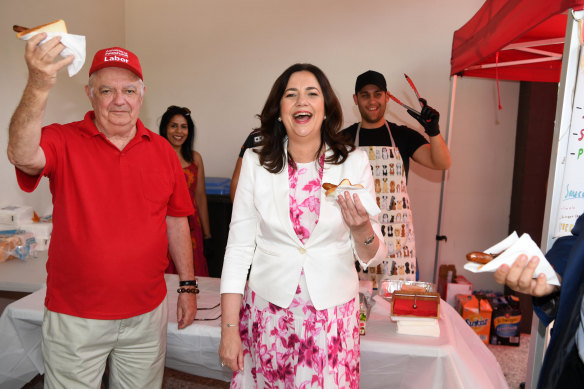 Henry and Annastacia Palaszczuk enjoying democracy sausages on the premier’s final election day.