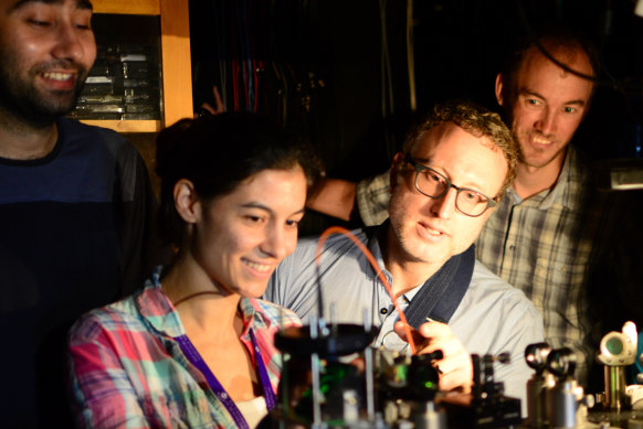 Warwick Bowen (middle right) with UQ researchers Waleed Muhammad, Caxtere Casacio and Lars Madsen aligning the quantum microscope.