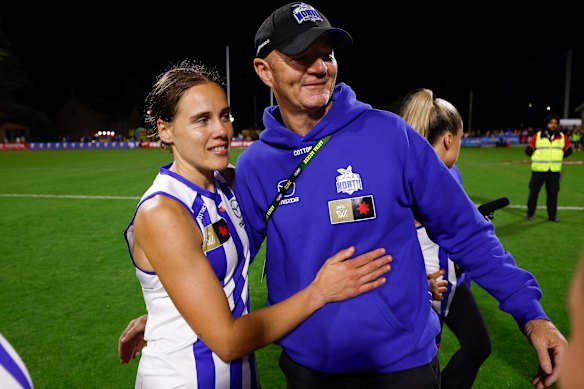 Jasmine Garner (left) and Darren Crocker, Senior Coach of the Kangaroos celebrate after their win over Hawthorn last round.