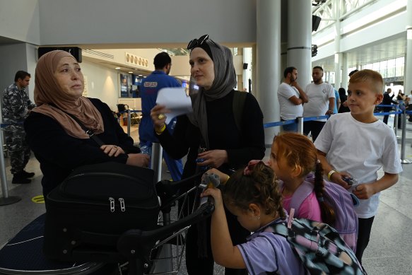 Amal Elriche (centre) and her children Alma, Ibtissam and Mahmoud Baker, prepare to leave Beirut airport on an evacuation flight.